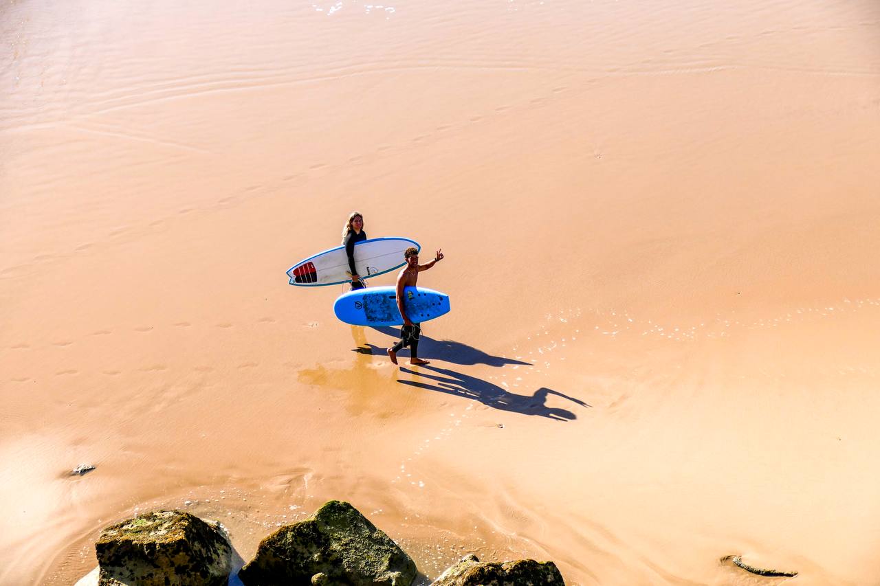 Surfers carrying boards to the beach near Taghazout