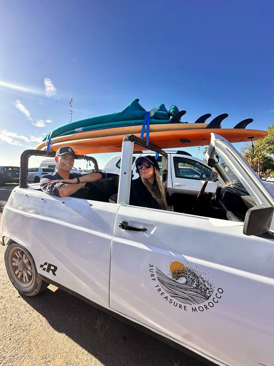 Surf camp transfer van loaded with surfboards in Aourir