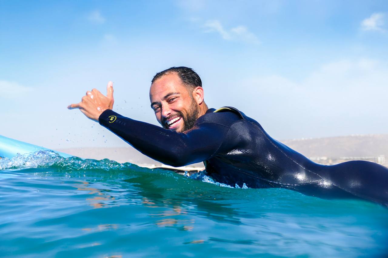 Smiling surfer in the ocean during a Surf Treasure Morocco session