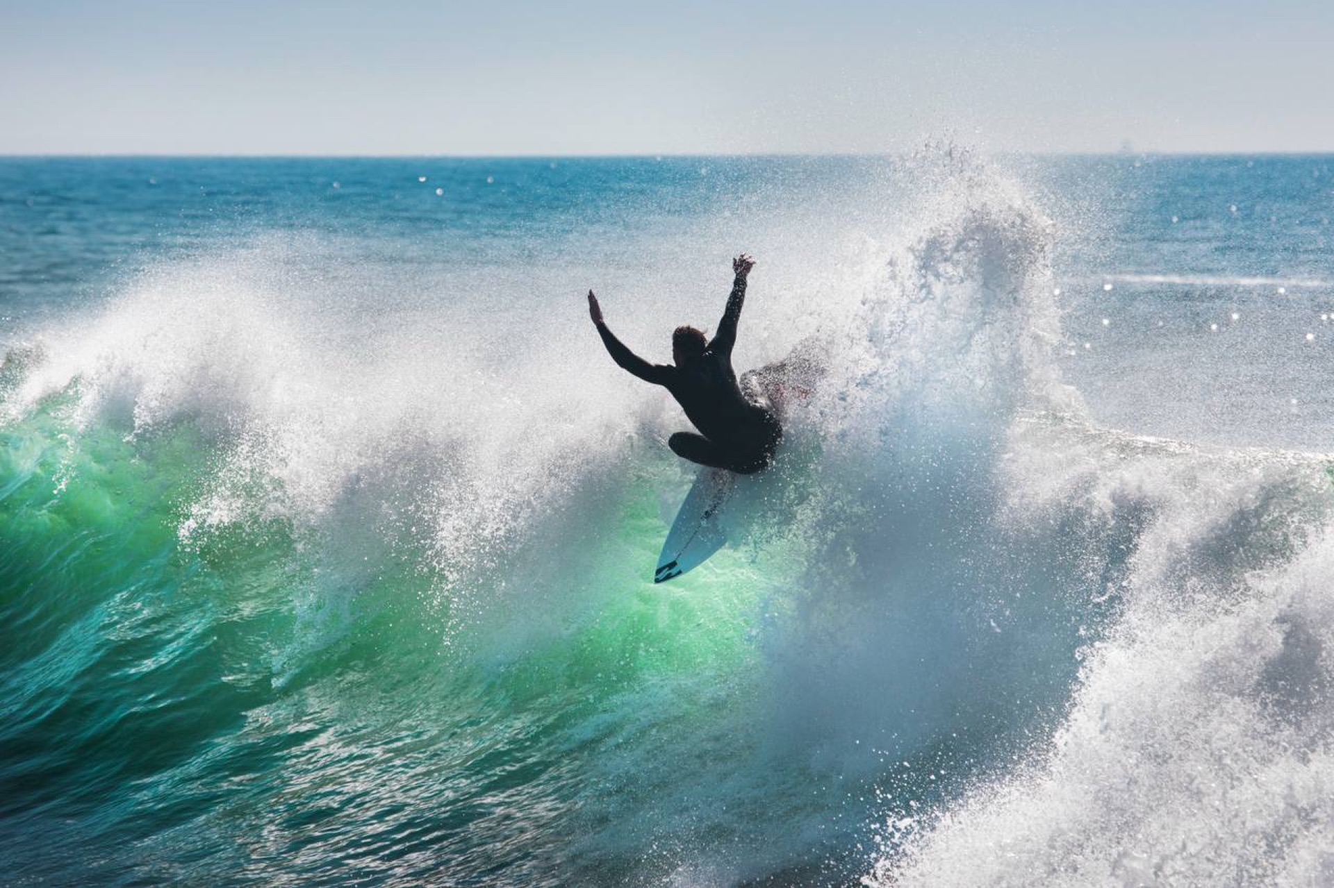 Surfer carving a wave at Anchor Point, Taghazout