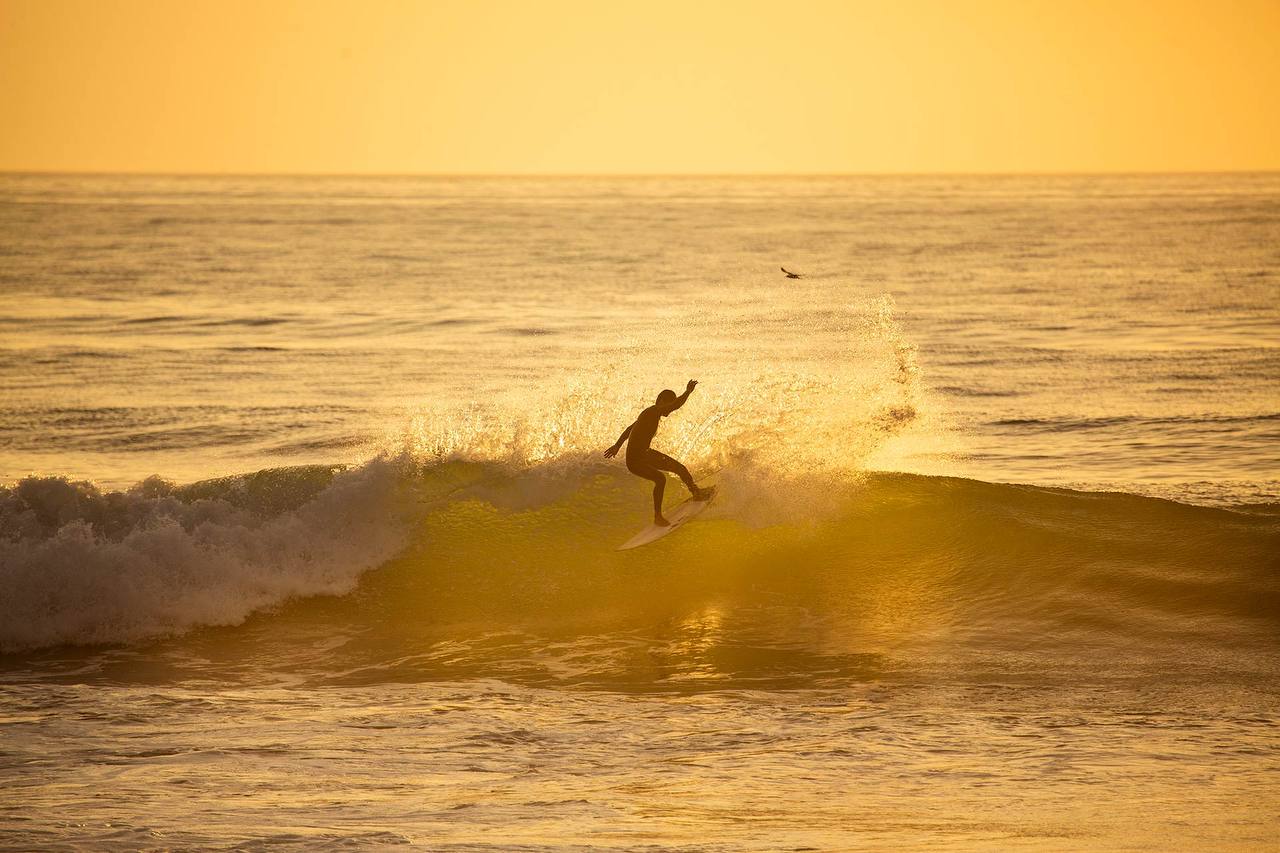 Golden hour surf session in Taghazout with rolling Atlantic waves